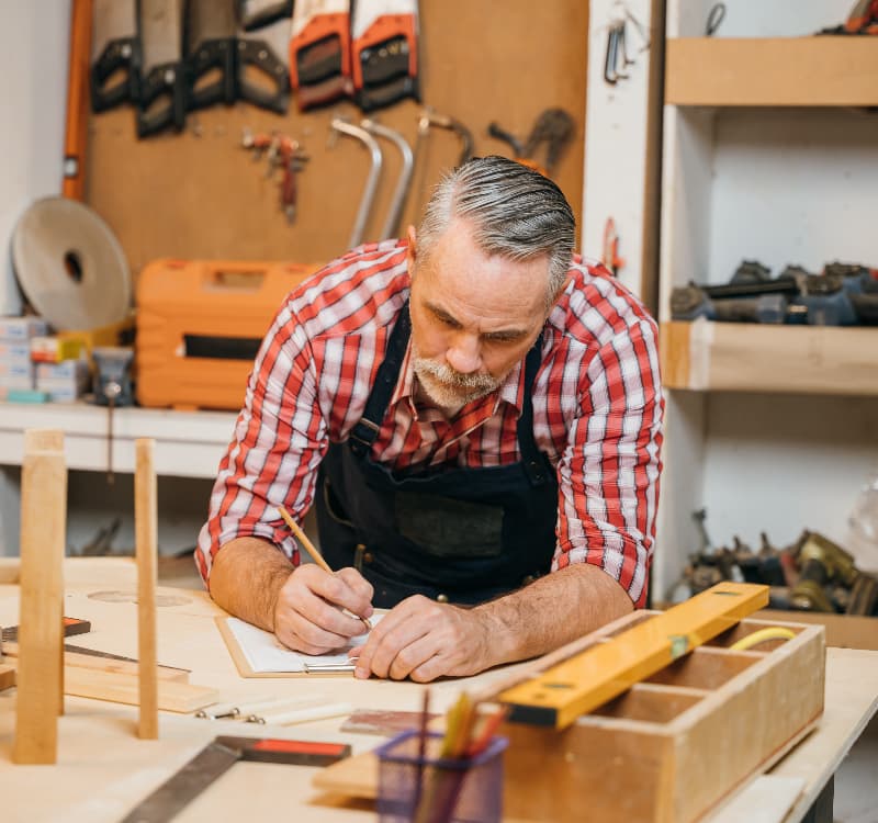 man in workshop working on a woodwork project